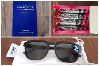 blue book, protein bars and black sunglasses