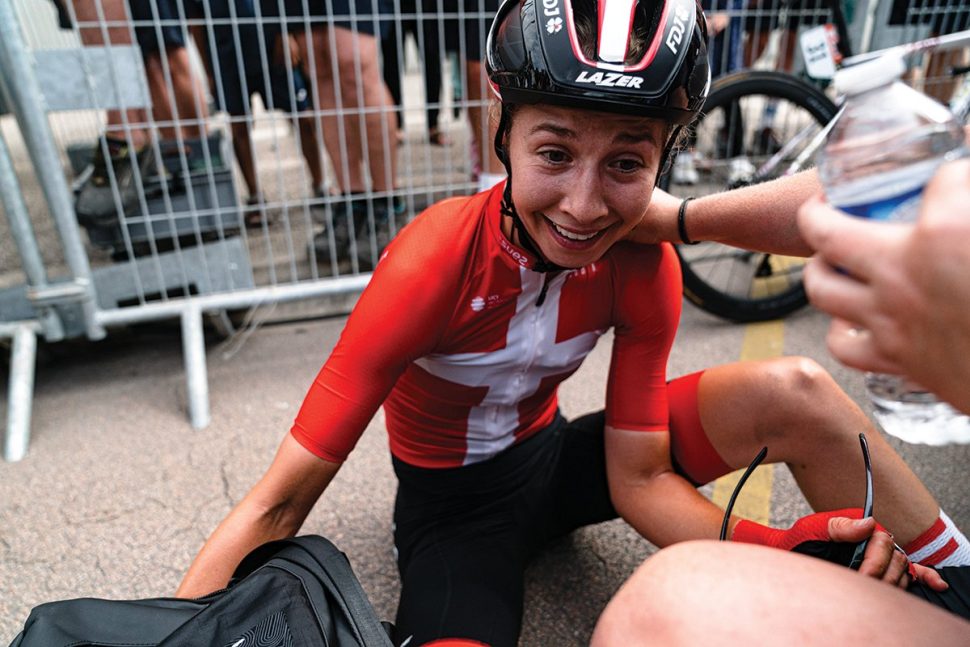 cyclist in red lies on floor smiling